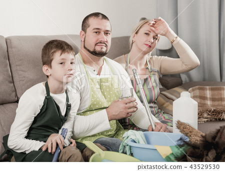 Tired parents with son dressed for cleaning Tired parents with son dressed for cleaning 43529530
