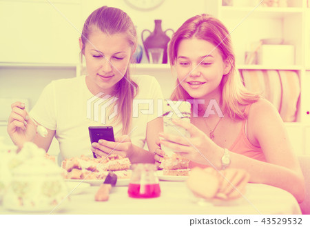 friends drinking tea with mobile phone friends drinking tea with mobile phone 43529532