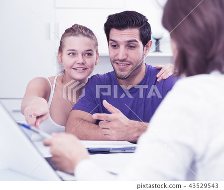 Young couple meeting financial adviser at home Young couple meeting financial adviser at home 43529543