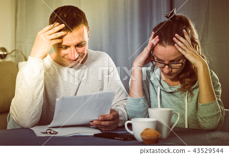 Couple struggling to pay bills Couple struggling to pay bills 43529544