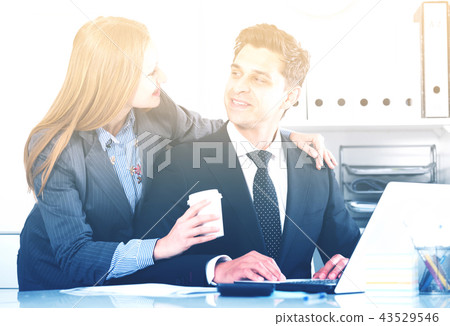 Adult business couple flirting in office Adult business couple flirting in office 43529546