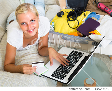 Woman booking tickets online . Woman booking tickets online . 43529669