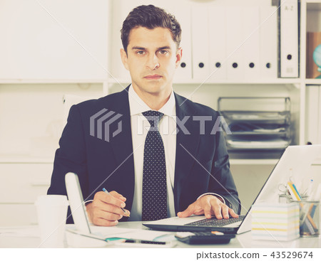 Businessman concentrating on work Businessman concentrating on work 43529674