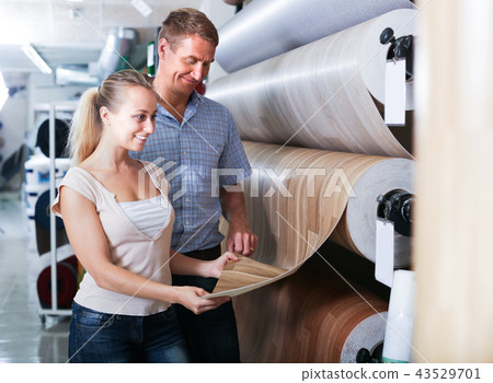 customers choosing linoleum in household section. 43529701