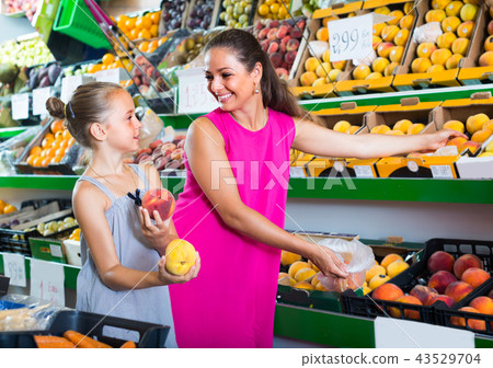 woman and girl buying peaches woman and girl buying peaches 43529704