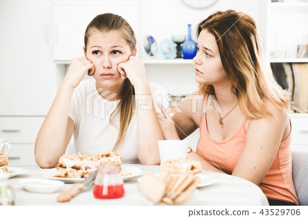 Portrait of female talking with sad girl friend Portrait of female talking with sad girl friend 43529706