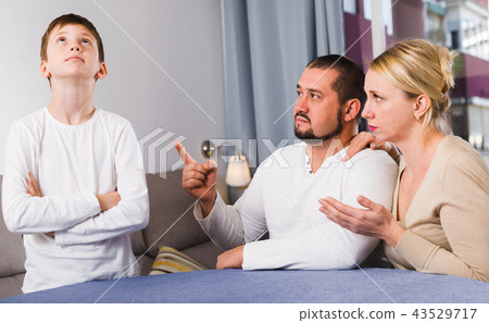 Upset parents berating son 43529717