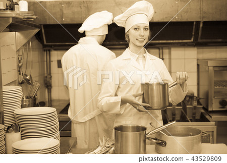Cooks cooking at professional kitchen Cooks cooking at professional kitchen 43529809