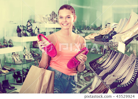 Girl searching for pair of new shoes 43529924