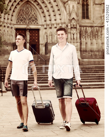 Male tourists walking the street 43529982