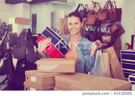 friendly teenager girl holding boxes in shoes boutique friendly teenager girl holding boxes in shoes boutique 43530000