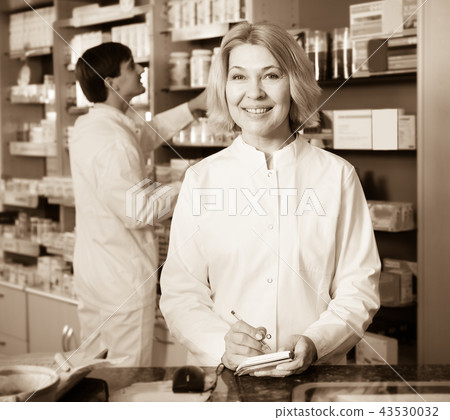 pharmaceutists working in chemist shop pharmaceutists working in chemist shop 43530032