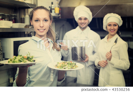 Waitress with plates at kitchen 43530256