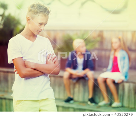 Offended boy with friends after quarrel 43530279