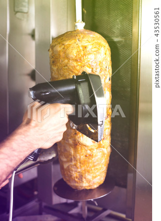 Closeup on cutting meat for kebab in restaurant Closeup on cutting meat for kebab in restaurant 43530561