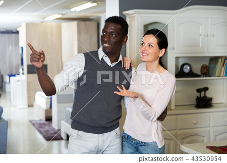 Adult woman with her husband are looking on modern furniture for their house Adult woman with her husband are looking on modern furniture for their house 43530954