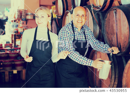 man and woman holding wine vessels man and woman holding wine vessels 43530955