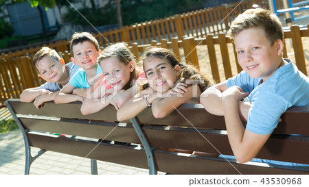 Glad children sitting on a bench Glad children sitting on a bench 43530968