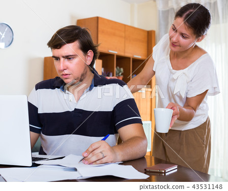 Wife taking care of working husband . 43531148