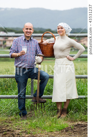Two mature farm workers taking a pause Two mature farm workers taking a pause 43531237
