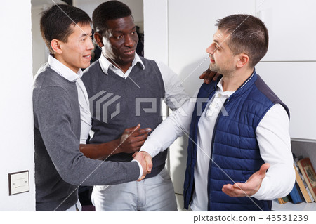 Adult male is welcoming his friends who visit him Adult male is welcoming his friends who visit him 43531239
