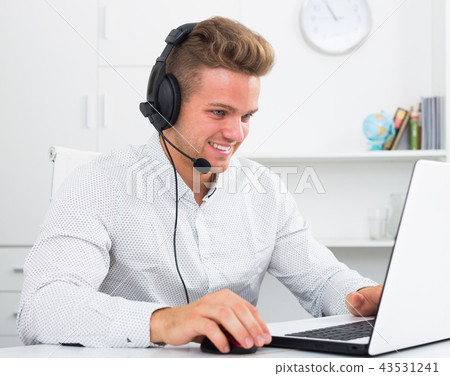 Young man working in call centre Young man working in call centre 43531241