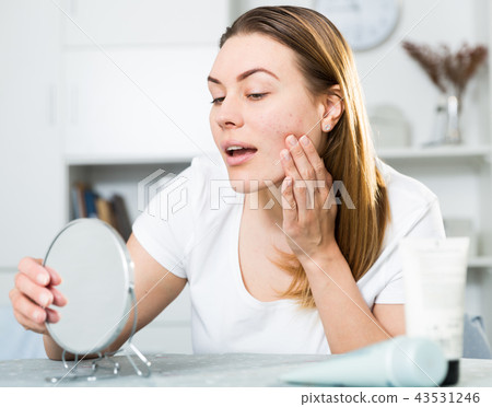 Young woman is satisfied of quality her skin in with mirror 43531246