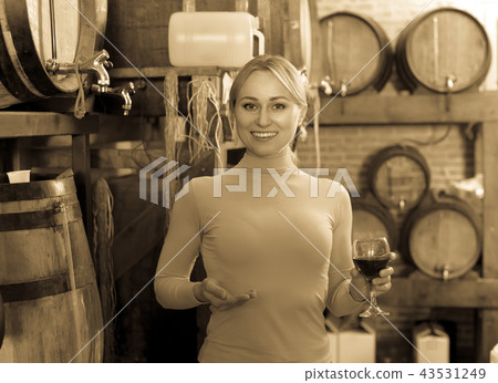 Woman selecting wine in wine house. Woman selecting wine in wine house. 43531249