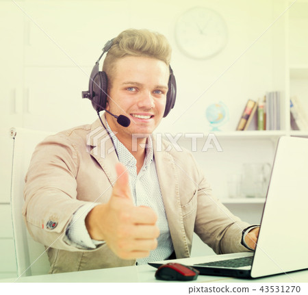 Happy man with headset and laptop Happy man with headset and laptop 43531270