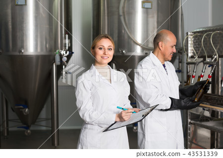 Man and woman working on brewery. 43531339