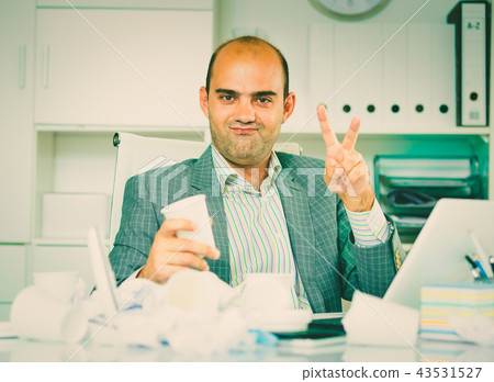 Cheerful businessman enjoying the excellent results Cheerful businessman enjoying the excellent results 43531527