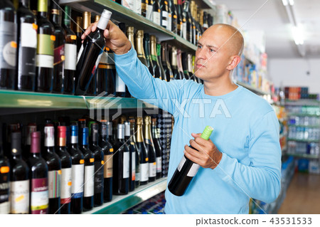 man selecting wine man selecting wine 43531533