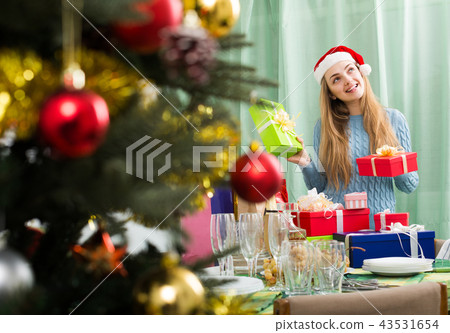 Girl with X-mas presents at home. Girl with X-mas presents at home. 43531654