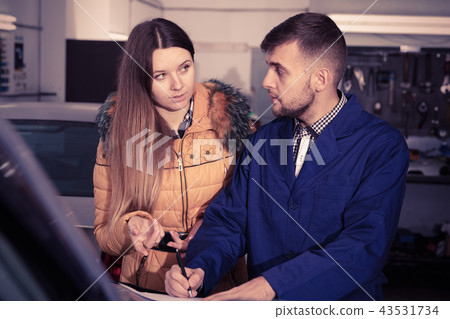 Woman client is dissatisfied of repair of her car in winter Woman client is dissatisfied of repair of her car in winter 43531734