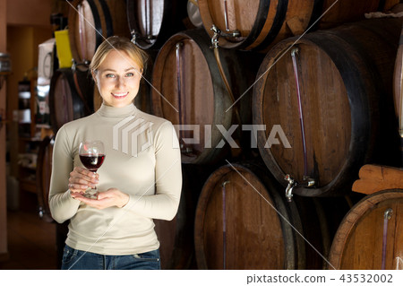 Woman having glass of wine in wine house Woman having glass of wine in wine house 43532002