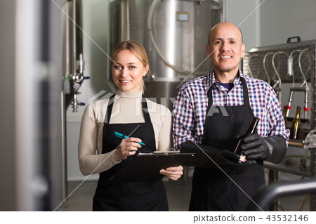Two brewery workers on beer factory. Two brewery workers on beer factory. 43532146