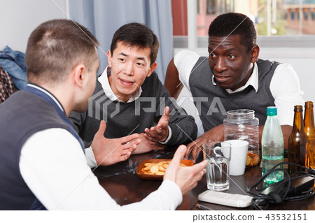 Cheerful men talking at home table Cheerful men talking at home table 43532151