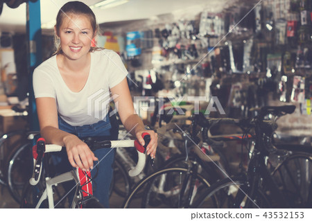 Portrait of nice girl posing with bicycle Portrait of nice girl posing with bicycle 43532153