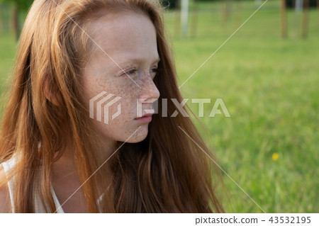 Beautiful sad little girl looks into distance Beautiful sad little girl looks into distance 43532195