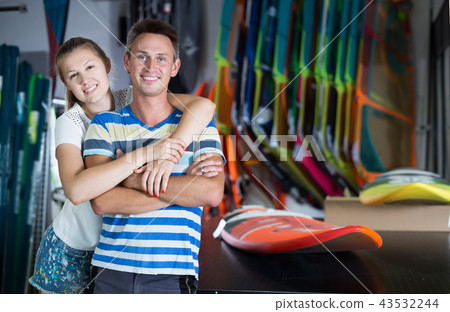 Active couple is choosing colorful boards Active couple is choosing colorful boards 43532244