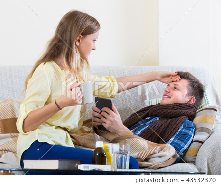 Wife taking care of husband with flue. 43532370