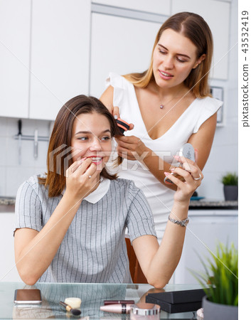 Friends talking and applying make up Friends talking and applying make up 43532419