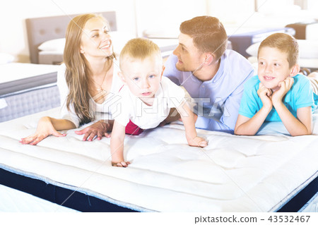 Little funny boy crawling on bed in salon Little funny boy crawling on bed in salon 43532467