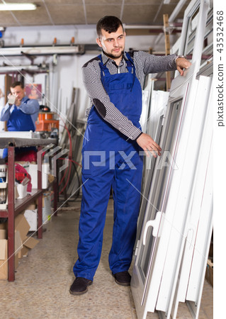 smiling professional labours with finished PVC profiles and windows smiling professional labours with finished PVC profiles and windows 43532468