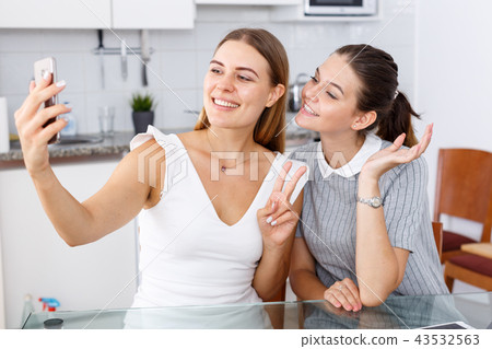 Two young girls taking selfie Two young girls taking selfie 43532563