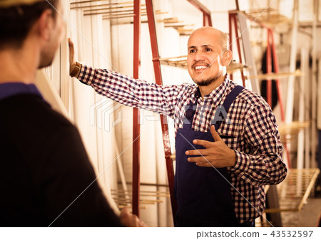 Two PVC industry workers in coveralls . Two PVC industry workers in coveralls . 43532597