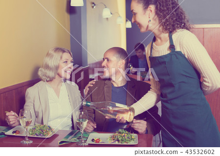 Waitress with mature guests . Waitress with mature guests . 43532602