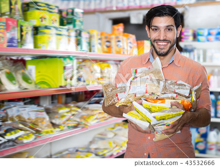 Portrait of nice male standing with purchases 43532666
