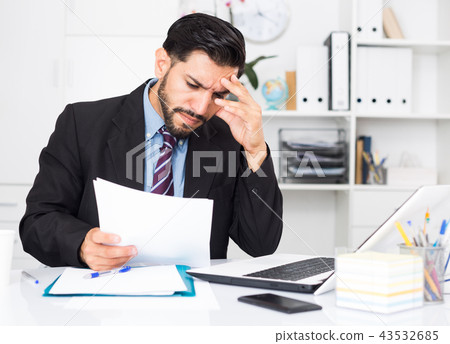 Adult businessman is sad because he is having issues at work place Adult businessman is sad because he is having issues at work place 43532685