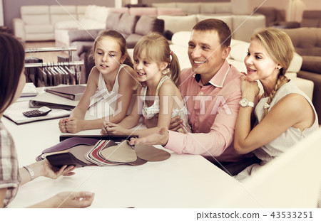 Man with wife and kids are consulting with the seller 43533251
